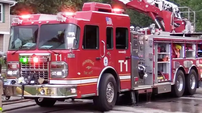 A red Naperville fire truck sits in front of a home.