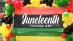 A banner saying "Juneteenth, Freedom Day," shines bright at the Juneteenth celebration in Naperville.