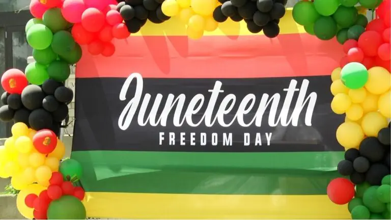 A banner saying "Juneteenth, Freedom Day," shines bright at the Juneteenth celebration in Naperville.