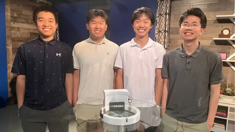 The four creators of the assistive headband, Eyerobic, built for visually-impaired swimmers, smile for a picture standing side by side.