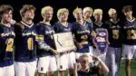 Neuqua boys lacrosse celebrates and holds SuperSectional Plaque after beating Lyons Township.