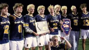 Neuqua boys lacrosse celebrates and holds SuperSectional Plaque after beating Lyons Township.