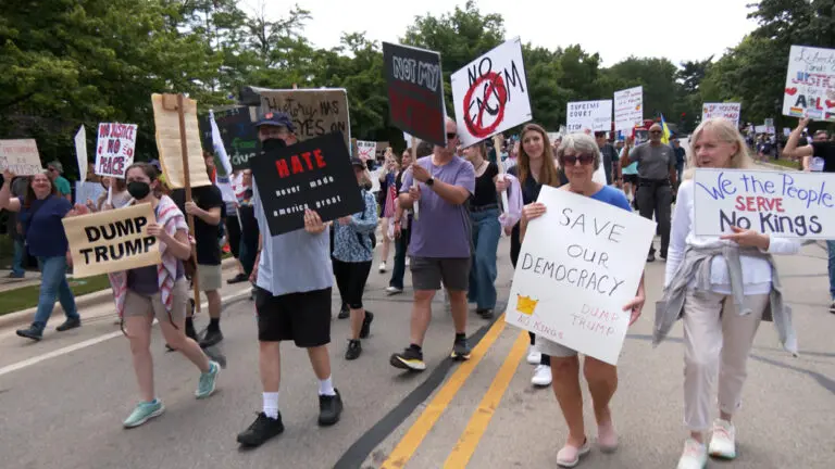 Protestors march in Naperville against President Donald Trump as part of nationwide No Kings mass protest