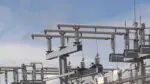 Electric posts and wires at power plant.