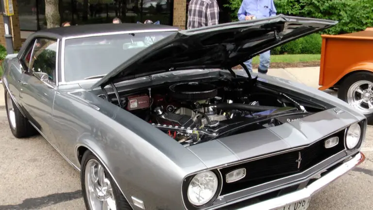 Classic silver car with hood open at vintage car show in downtown Naperville