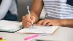 Close up of student filling in scantron form on desk for story on District 203 asssessment tool