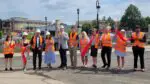 Naperville officials cheer after cutting a ribbon to officially open the Washington Street Bridge.