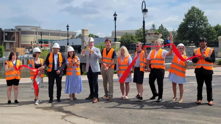 Naperville officials cheer after cutting a ribbon to officially open the Washington Street Bridge.