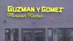 Close up of Guzman y Gomez restaurant sign at first Naperville location