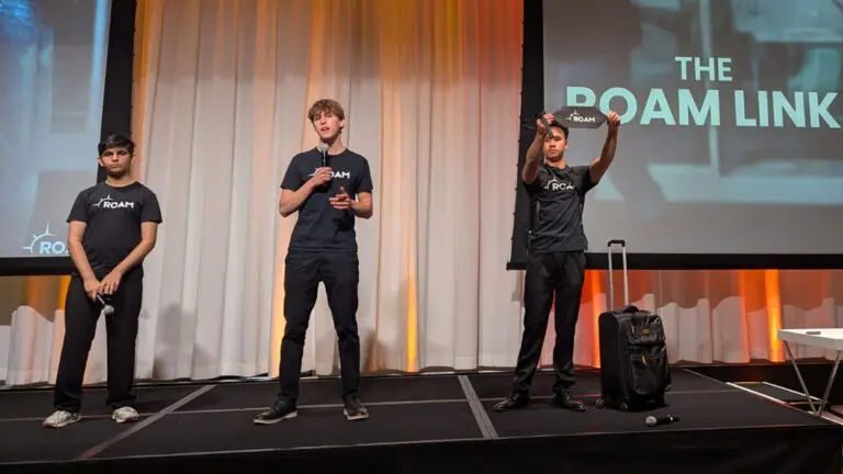 Three students that form the company Roam Travel take center stage at National Pitch Night in Chicago, demonstrating their product the Roam Link