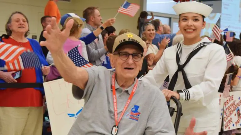 Ralph Bertolacini waving at the crowd at Chicago Midway International Airport