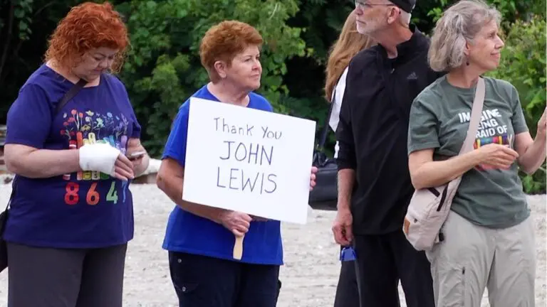 A protester holds a sign reading "Thank you John Lewis," during the nationwide John Lewis Day of Action.