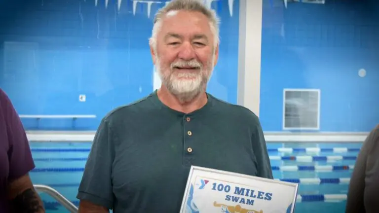 Naperville’s Greg Fyksen smiles with the plaque after completing the YMCA 100 Mile Swim Club Challenge in 94 days.
