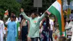 A man waves an Indian flag as he takes part of the annual India Day Parade and celebration.