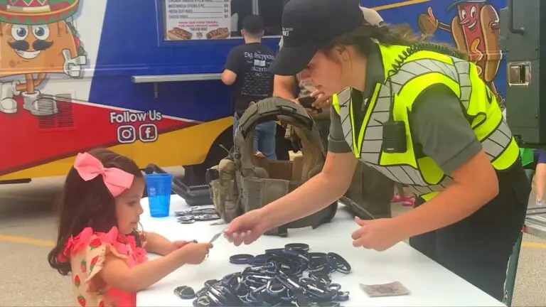 A police personnel handing a sticker to a child at last year's National Night Out event