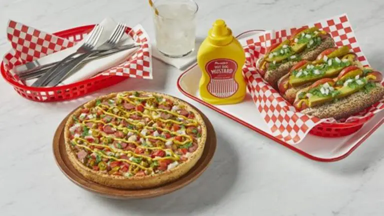 Photo of Chicago Dog Deep Dish pizza along with Portillos hot dog and silverware
