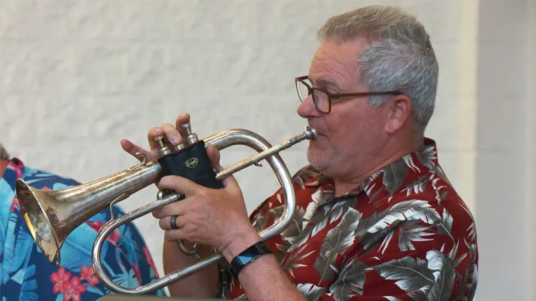 A Brass Tracks Big Band trumpet player in a Hawaiian shirt.
