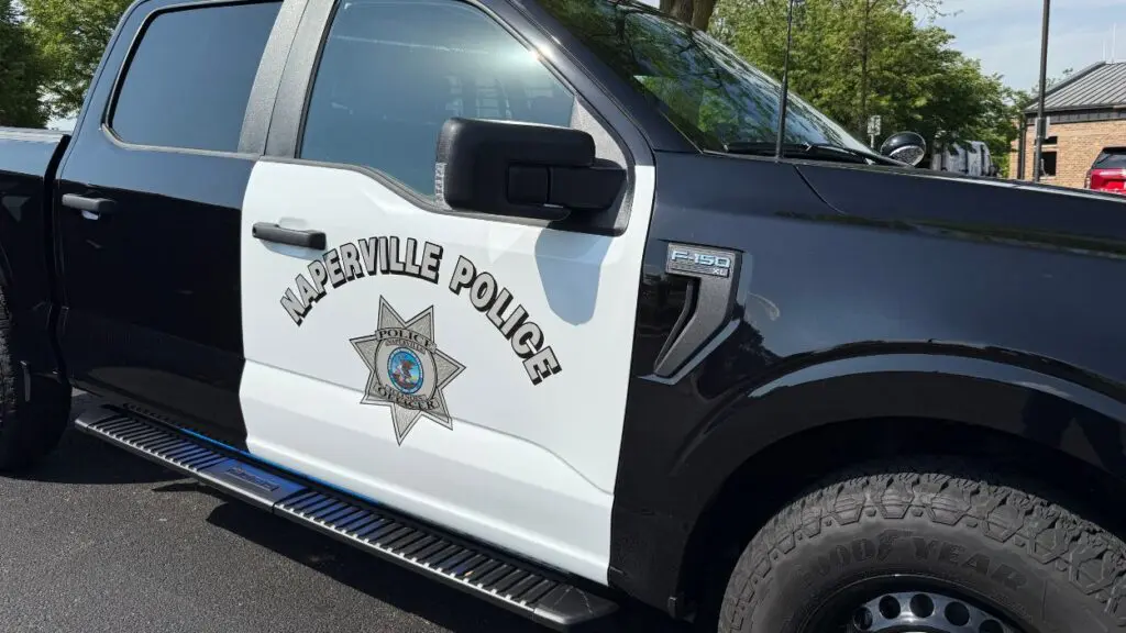 Aurora man killed in early morning motorcycle crash in Naperville. image of police pick up truck
