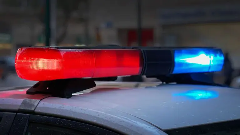Aurora police investigate Station Blvd. shooting; suspect still at large. CU of police lights