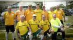 The Half Century Club team takes a picture in front of goal at the Days of Glory Tournament in Aurora.