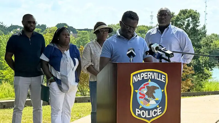 Gbenga Abosede, the husband of a missing Naperville woman Sinmi Abosede, gives a statement outside the Naperville Police Department.