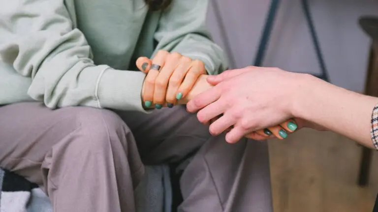 Close up of person holding another person's hands