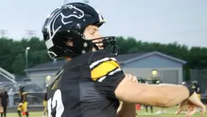 Metea Valley football quarterback Charles Larson warms up before taking on Downers Grove South.