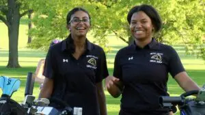 Metea Valley Girls Golf athletes smile at the camera for a DVC matchup.