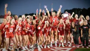 Naperville Central Flag Football celebrates at midfield after beating Rosary.