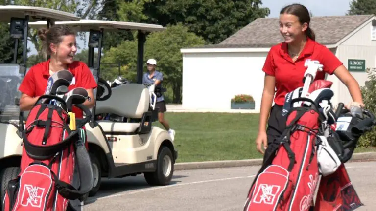 Naperville Central girls golf members walk to the tee before playing Neuqua.