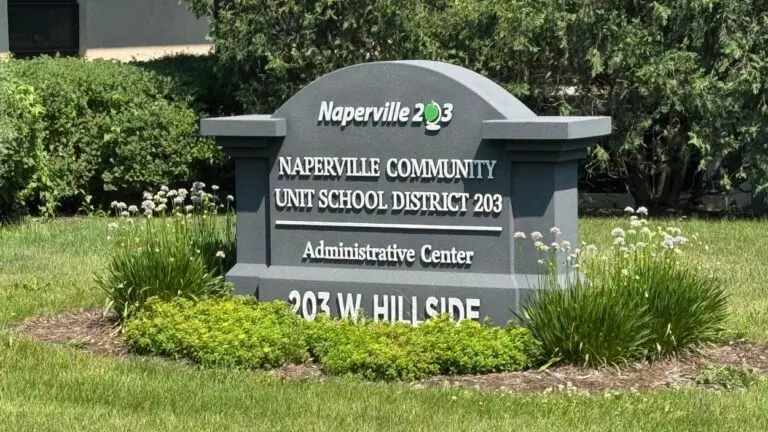 Close up of Naperville School District 203 Administration Building sign in grass