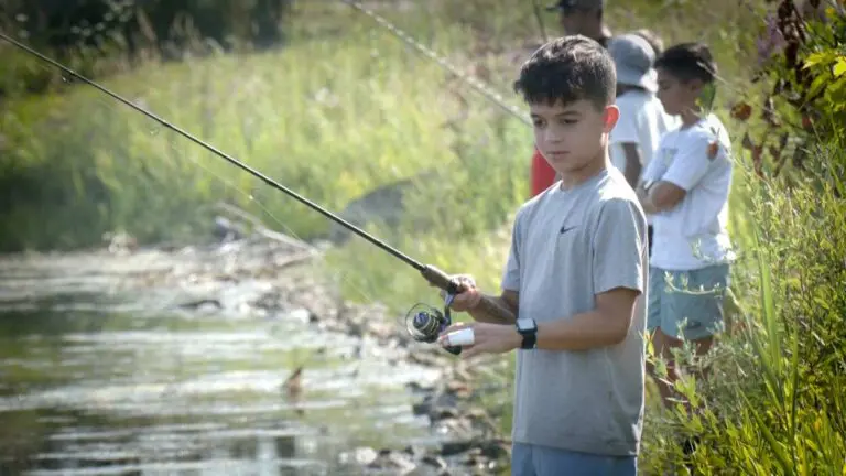 Kid fishes at the Elite Chess, Chess and Fishing combo camp.