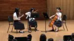 A trio of OPUS students perform on the stage of the Wentz Concert Hall