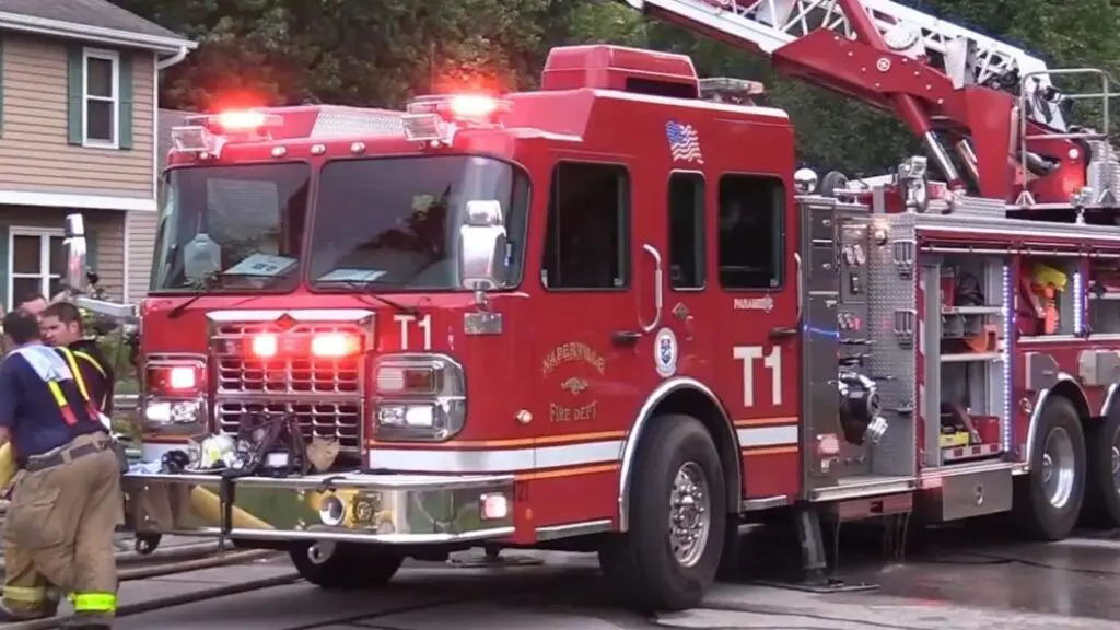 Overnight vehicle fire in Naperville sparks townhome, causing $110K in damages. Fire truck at scene