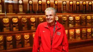 Al Carius in front of trophy case
