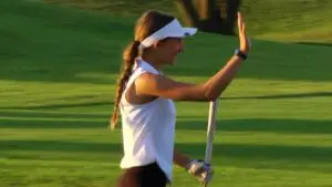 Ashley Jenner chips from the bunker to the pin for Metea Valley girls golf
