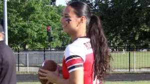 Flag Football Player smiles and prepares to throw
