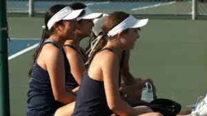 Neuqua Valley girls tennis knocks off Metea Valley in a DVC battle as the Wildcats watch and cheer.