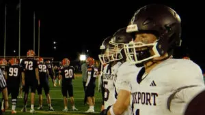 Lockport Porters football hangs on to win as they warm up.