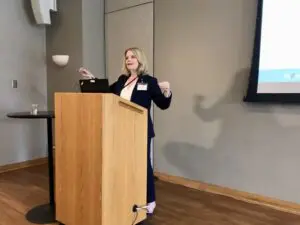 Sarah Martinez speaking at podium during the Early Childhood Mental Health Symposium.