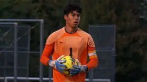 Soccer player holds the ball for Waubonsie Valley.