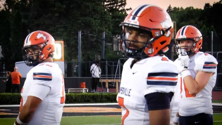 Naperville North football warms up the offense as players look for a play before playing Libertyville.