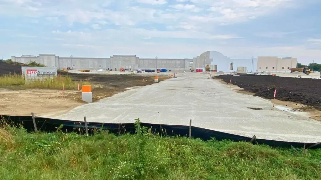 Wide shot of new Woodman's Food Market under construction in Plainfield with gravel driveway leading to store