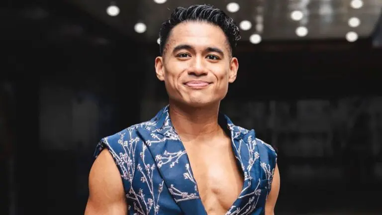 Benet Academy alum Jordan De Leon smiles while standing outside the Winter Garden Theater in New York City.