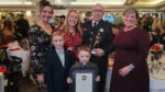 Firefighter/Paramedic Philip Carmody poses with the George Winckler award with this family.