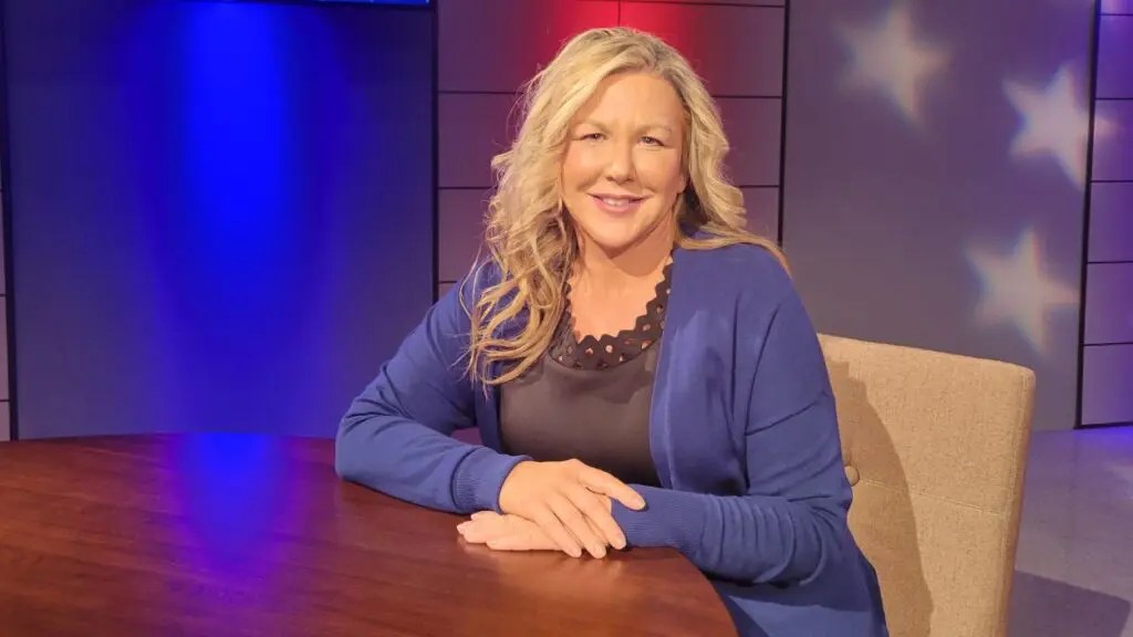 Melissa Kelley Black seated at table in studio