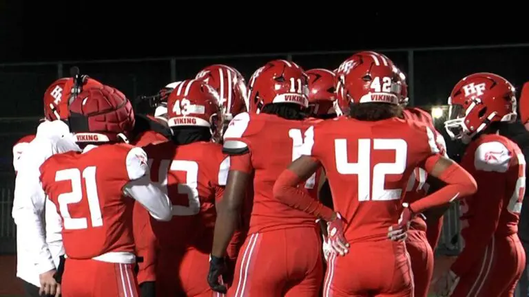 Homewood-Flossmoor football clinches play as they huddle on the field.