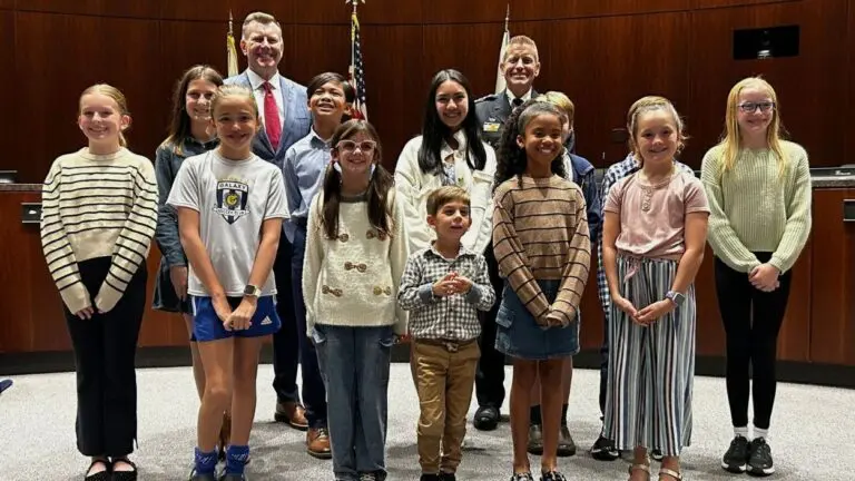 Naperville area private school students who contributed to Crime Prevention Calendar stand with mayor and police chief