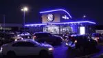 7 Brew drive thru coffee shop at night with cars lined up for the drive thru