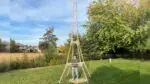 Naperville teen Eric Klabel stands under his world record-setting toothpick tower.
